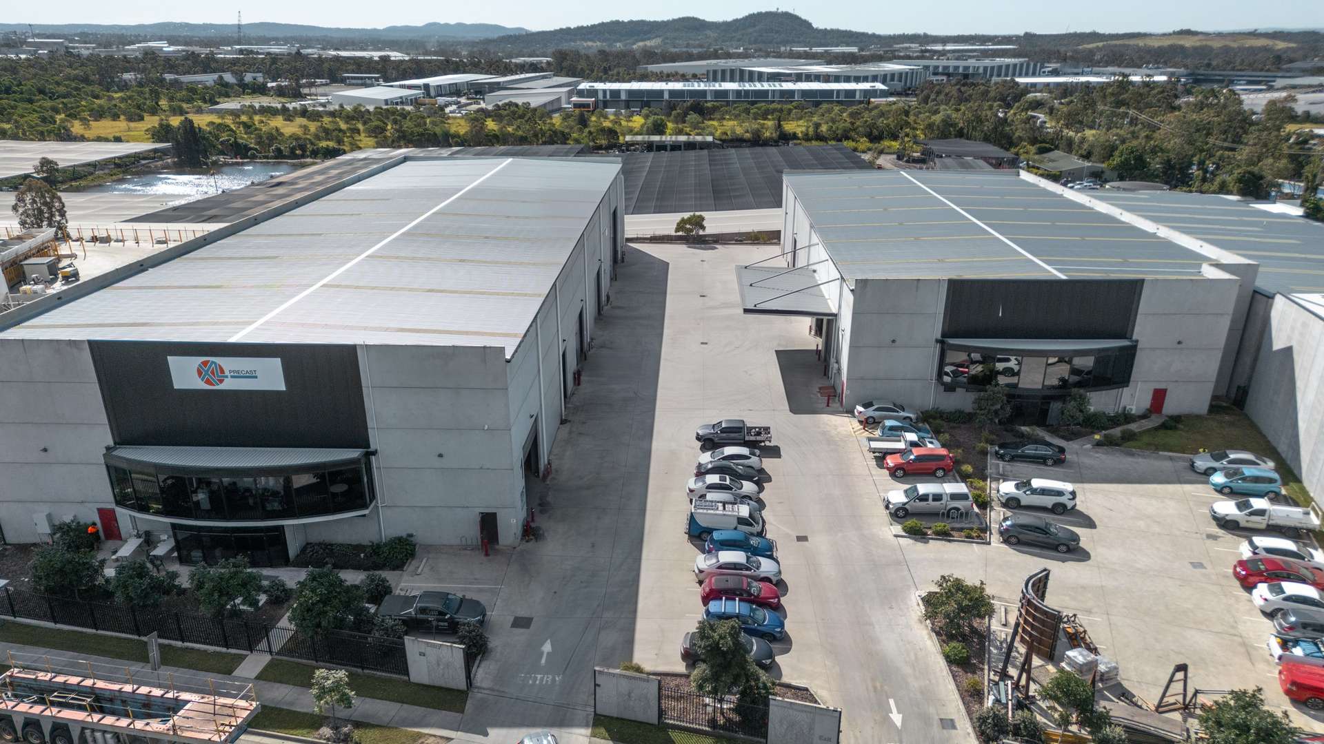 Yatala, Gold Coast — the estate from the air, the main building square on with the hinterland behind